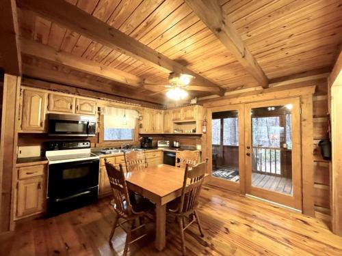 a kitchen with a table and chairs in a cabin at Peaceful Tellico View Home with Private Hot Tub in Tellico Plains