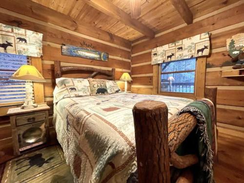 a bedroom with a bed in a log cabin at Peaceful Tellico View Home with Private Hot Tub in Tellico Plains