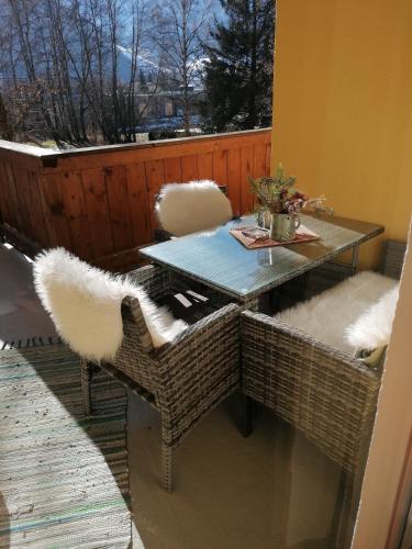 a table and chairs on a balcony with a view at Heilbad Burgwies in Stuhlfelden