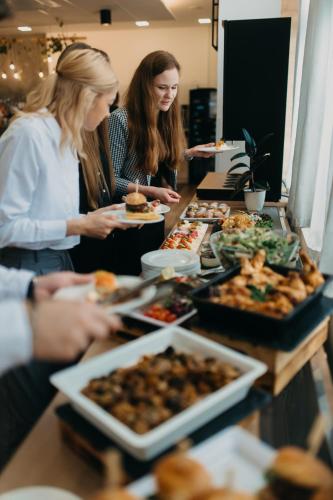 a group of people standing around a table with food at OREA Resort Santon Brno in Brno