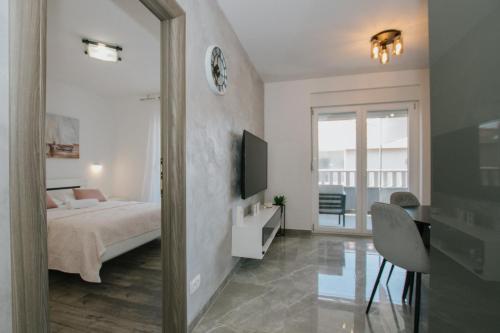 a bedroom with a bed and a mirror at Royal Blue House 2 in Kaštela