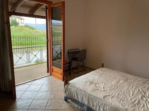 1 dormitorio con 1 cama y puerta corredera de cristal en greengold Holiday Home - Ancient Pisa en Olympia