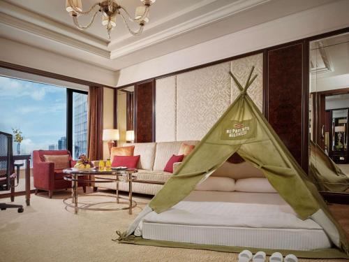 a bedroom with a bed with a tent on it at Shangri-La Kuala Lumpur in Kuala Lumpur