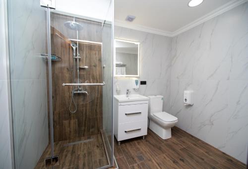 a bathroom with a shower and a toilet and a sink at 14 Floor Hotel in Yerevan