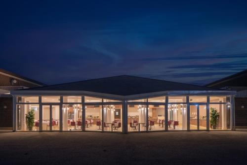 a pavilion with tables and chairs at night at UNA Hotels Bologna San Lazzaro in San Lazzaro di Savena