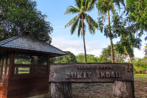 a sign in front of a building in a park at Hotel & Villa Bukit Indah Saumlaki by LeGreen in Saumlaki
