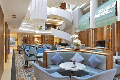 a lobby of a hotel with chairs and tables at Radisson BLU Hotel Yerevan in Yerevan