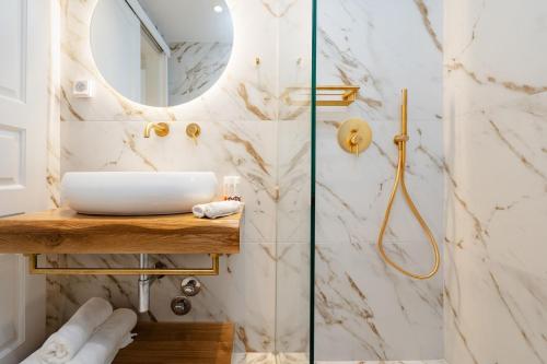 a bathroom with a sink and a shower at Naxos Petite In Town in Naxos Chora