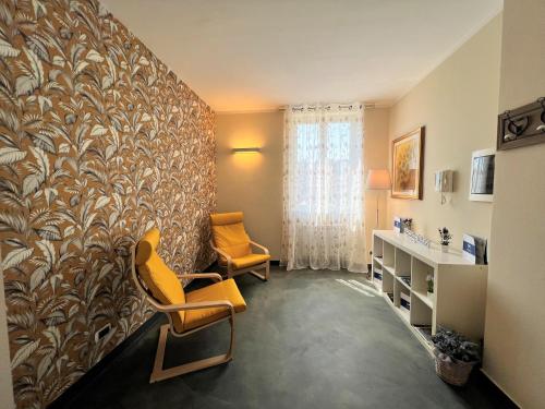 a living room with two chairs and a wall at House Sturla by Holiday World in Genova