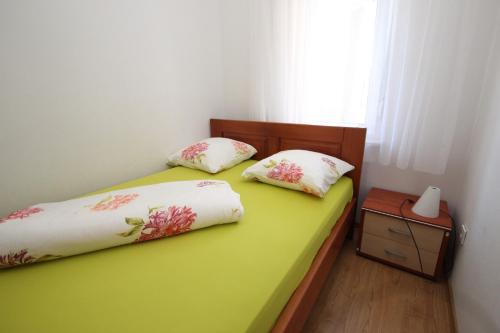 a bedroom with two beds and a window at Apartments Rose in Poreč