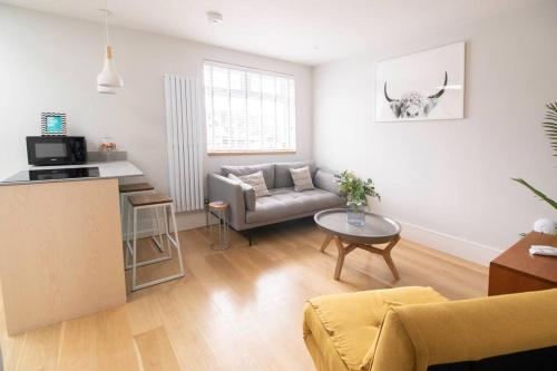 a living room with a couch and a table at Hyper-central Newquay, sleeps 3 in Newquay