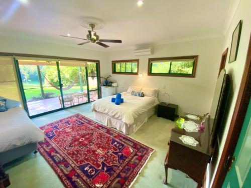 a bedroom with two beds and a rug at Evermoore Homestead in Gleniffer