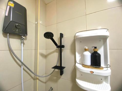 a soap dispenser on the wall of a bathroom at Por jai’s House in Campson