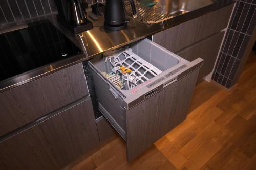 a kitchen with an open dishwasher in a drawer at LB1 美都津山庵別邸Bitotsuyama-an Bettei in Tuyama