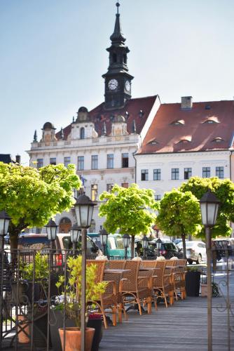 a building with a clock tower on top of it at City Hotel Morris in Česká Lípa