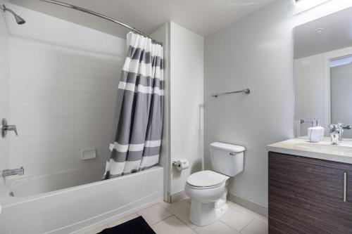 a bathroom with a toilet and a shower and a sink at Lower Nob Hill 2BR w Roofdeck BBQ nr Shops SFO-183 in San Francisco