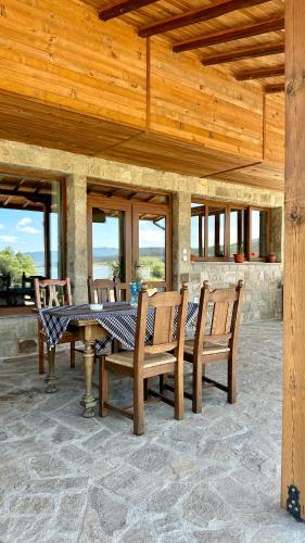 a wooden table and chairs on a patio at ВАЛ -МАЦА-7- яз Жребчево in Tvŭrditsa