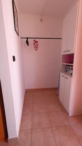 a small kitchen with a heart on the wall at La veranda del Melograno - Pisticci in Pisticci