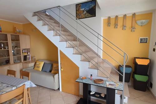 a living room with a staircase with a couch under it at La veranda del Melograno - Pisticci in Pisticci