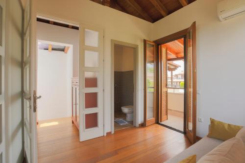 a living room with a door open to a toilet at Afitos Hidden Gems #FeelsLikeHome in Afitos