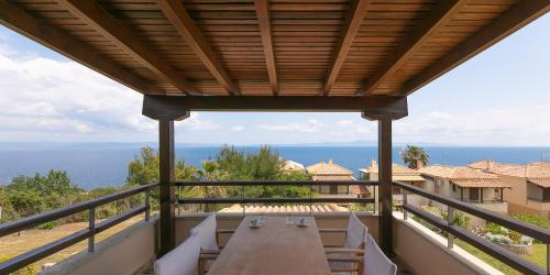 a table on a balcony with a view of the ocean at Afitos Hidden Gems #FeelsLikeHome in Afitos