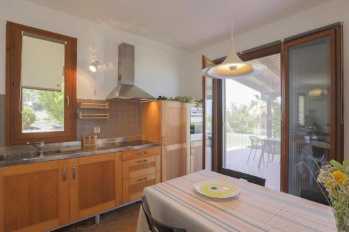 a kitchen with a table and a dining room at Afitos Hidden Gems #FeelsLikeHome in Afitos