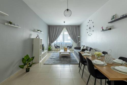 a dining room and living room with a table and chairs at Supurb 2 Bed Room Apt Sea Front (Side View) in Abu Dhabi