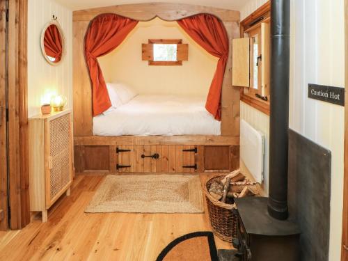 a small bedroom with a bed in a tiny house at Bracken Fern in Richmond