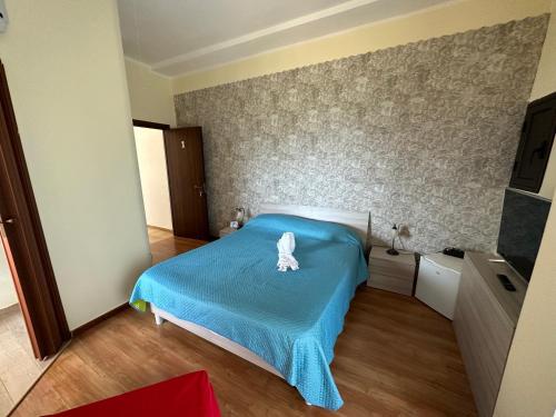 a bedroom with a blue bed with a white butterfly on it at Baia dei turchi locazione turistica in Realmonte