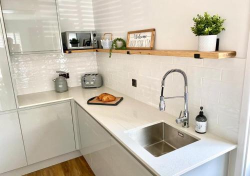 a kitchen counter with a sink and a sink at ‘The Loft’ - Apartment by the sea in Combe Martin