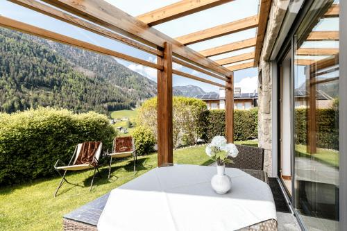 a table and chairs on a patio with a view of mountains at Apartments Chalet Anna in Ortisei