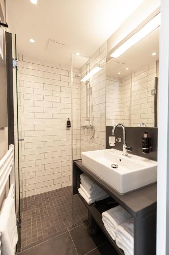 フェヒタにあるibis Styles Vechtaの白い洗面台とシャワー付きのバスルーム
