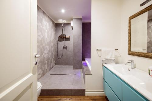 a bathroom with a shower and a toilet and a sink at La Cuntana Design Home in Potenza
