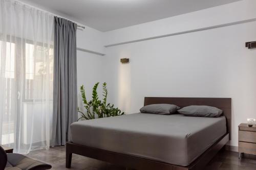 a bedroom with a bed and a large window at Pensiunea Grand in Eforie Nord