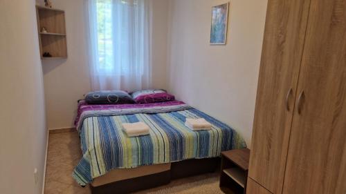 Habitación pequeña con cama y ventana en Anastasija en Kotor