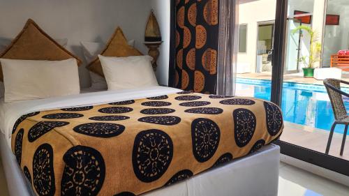 a bedroom with a bed and a swimming pool at Villa das Arábias Boutique Hotel in Maputo