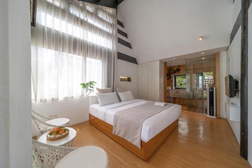 a bedroom with a large bed and a large window at The Bivou Lijiang in Lijiang