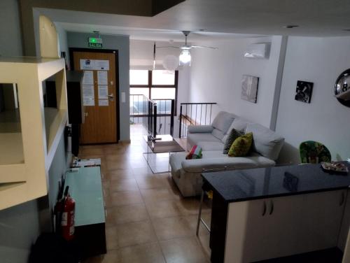 a living room with a couch and a table at ALOJAMIENTO LOS DINOSAURIOS in Cuenca