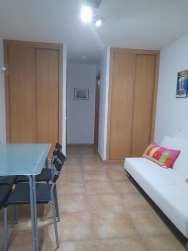 a living room with a couch and a table at ALOJAMIENTO LOS DINOSAURIOS in Cuenca