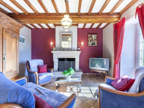een woonkamer met een bank en een tv bij Holiday Home Les Chardonnets - BNV400 by Interhome in Biniville