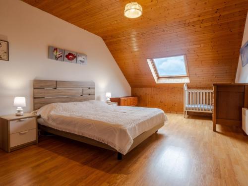 a bedroom with a bed and a wooden ceiling at Holiday Home La Jolie Vague by Interhome in Beaubigny