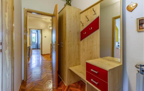 een kamer met een rode dressoir en een spiegel bij 4 Bedroom Beautiful Home In Pula in Pula