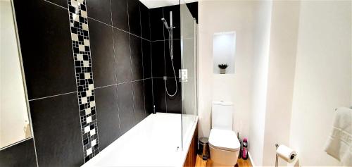 a bathroom with a shower and a toilet at Cliftonville Heights - 2 bed Home away from Home in Northampton