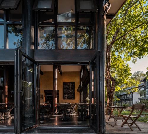 a house with glass doors and a patio at The Bivou Lijiang in Lijiang