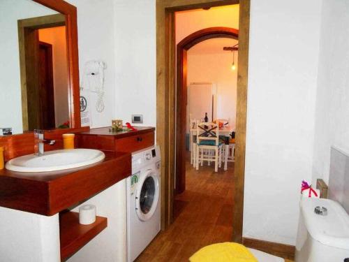 a bathroom with a sink and a washing machine at Apartamento deluxe Betancort in La Asomada