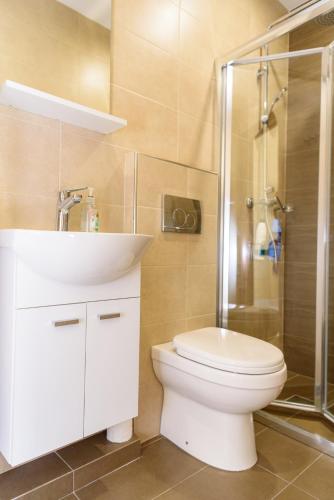a bathroom with a toilet and a sink and a shower at Casa Deguara townhouse Rabat Malta in Rabat
