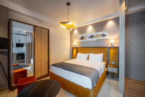 a hotel room with a bed and a chair at Gori Apartments in Gori