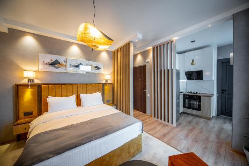 a bedroom with a large bed in a room at Gori Apartments in Gori