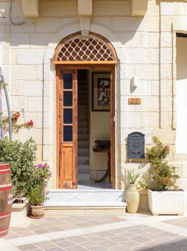 an entrance to a building with a wooden door at Casa Deguara townhouse Rabat Malta in Rabat