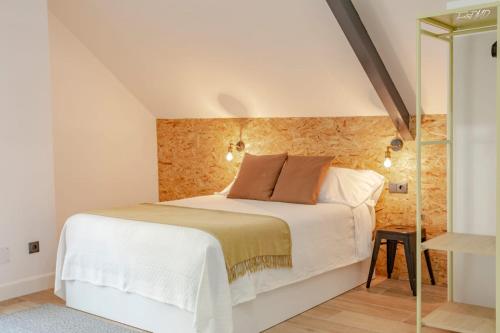 1 dormitorio con cama blanca y ducha acristalada en Apartamentos As Barxas Playa, en Moaña